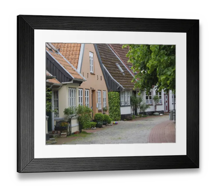 Framed Print : Picturesque half-timbered houses on a cobbled lane with many plants and decorations