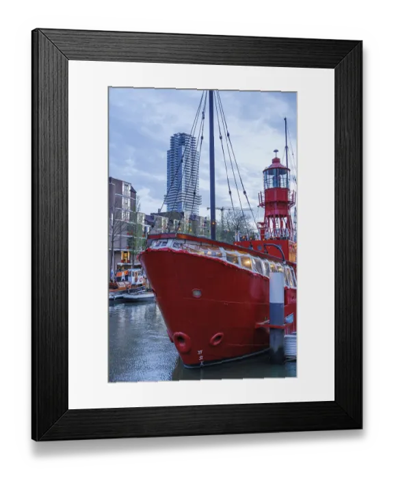 Framed Print : A red lighthouse ship in the water under modern high-rise buildings in the city