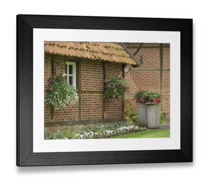 Framed Print : A rustic half-timbered house with hanging baskets and lush vegetation Framed Print : A rustic half-timbered house with hanging baskets and lush vegetation