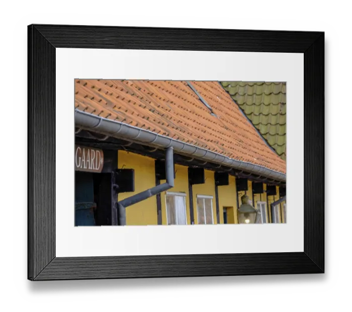 Framed Print : Engaged roofs and windows of a half-timbered house with yellow walls and tiles