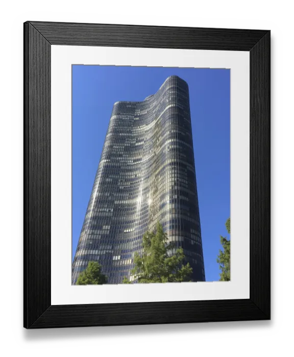 Framed Print : Tall modern wave design skyscraper against clear blue sky