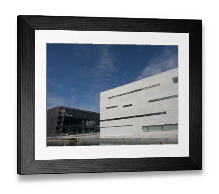 Framed Print : Modern buildings on the waterfront under a blue sky with scattered clouds