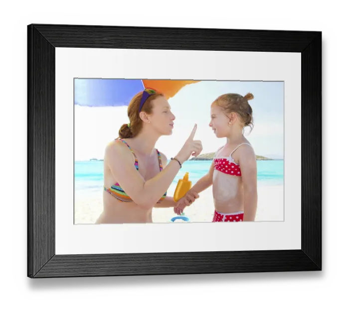 Framed Print : Daughter and mother in beach with sunscreen in bikini