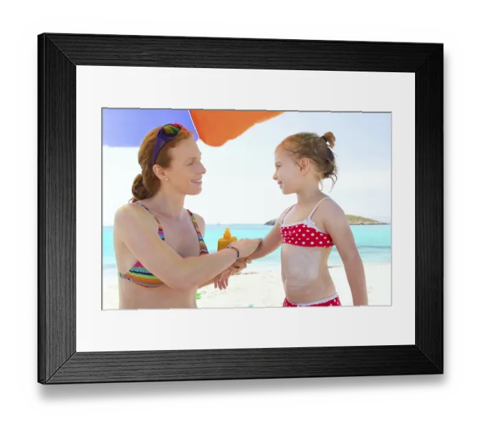 Framed Print : Daughter and mother in beach with sunscreen in bikini Framed Print : Daughter and mother in beach with sunscreen in bikini