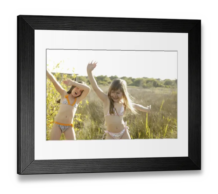 Framed Print : Two girls dancing outside in the park in bikini