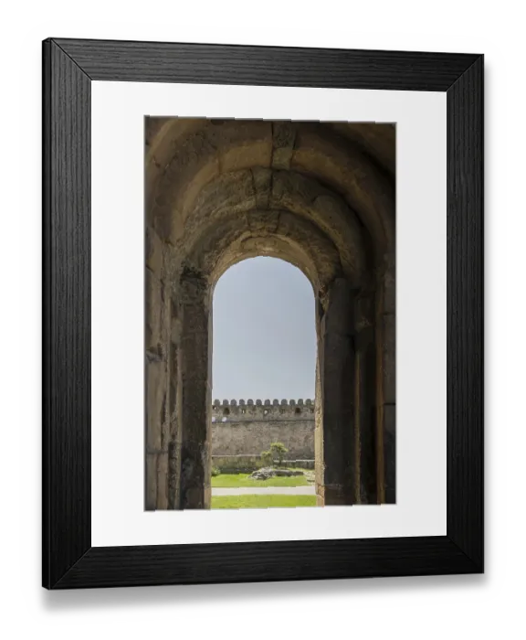 Framed Print : The ancient fortress wall is visible in the arch