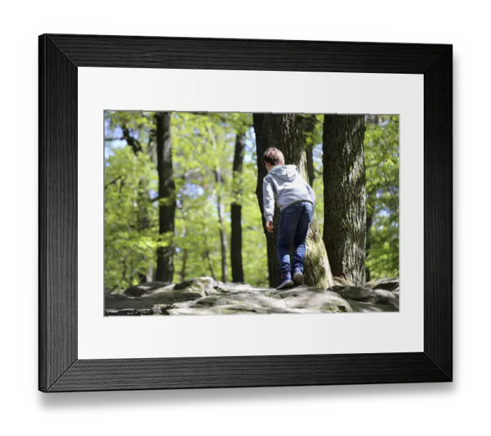 Framed Print : Boy climbing on the sea of rocks below the Kalmit in the Palatinate Forest