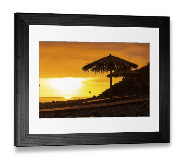 Framed Print : Orange sunset on the umbrellas at Ponta do Sol beach Framed Print : Orange sunset on the umbrellas at Ponta do Sol beach