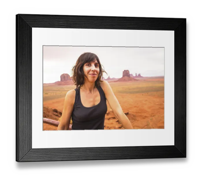 Framed Print : A young woman looking in a cloudy Monument Valley National Park