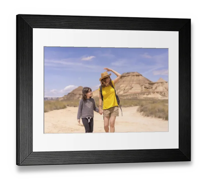 Framed Print : Horizontal frontal view of a mum and girl holding hands strolling for an arid national park Framed Print : Horizontal frontal view of a mum and girl holding hands strolling for an arid national park