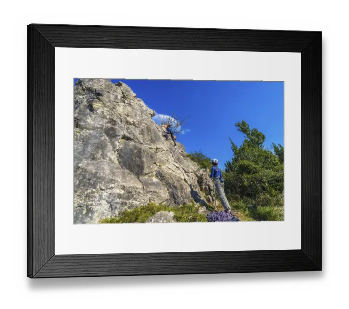 Framed Print : Two female rock climbers scaling a steep rock face