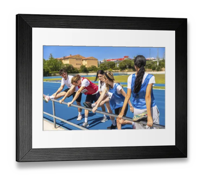 Framed Print : Runners stretching their legs on a vibrant blue track