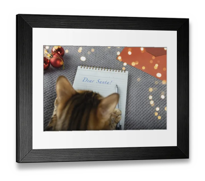 Framed Print : Bengal cat is writing a Christmas letter to Santa Claus Framed Print : Bengal cat is writing a Christmas letter to Santa Claus