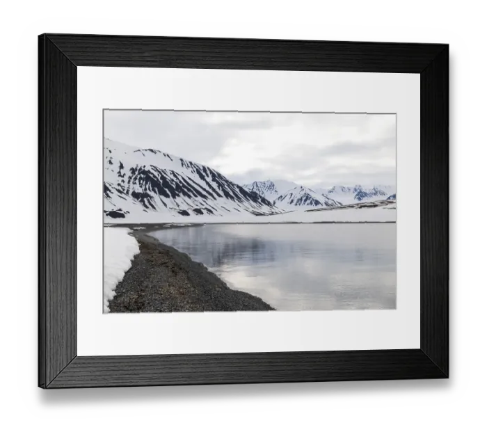 Framed Print : Pebble beach in a bay, mountain range