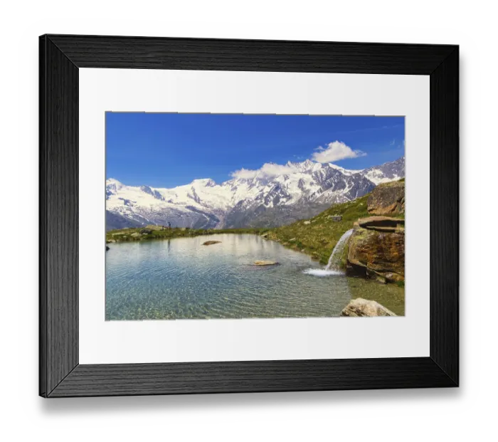 Framed Print : Small waterfall flows into a clear mountain lake against a mountain backdrop