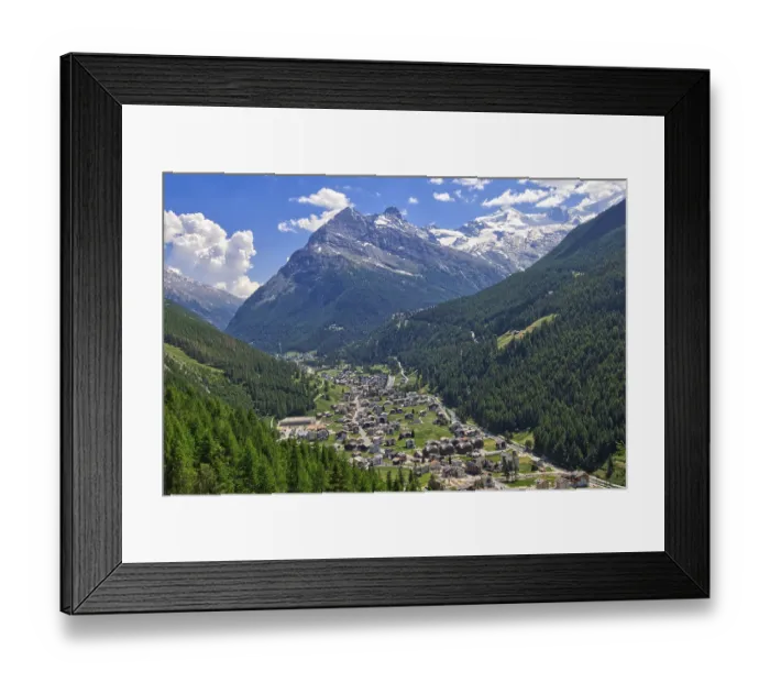 Framed Print : An idyllic Alpine village nestled in a green valley
