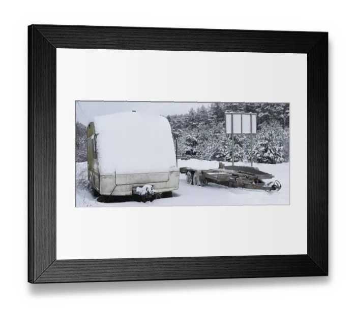 Framed Print : Broken tourist car trailer covered with snow in the winter forest landscape
