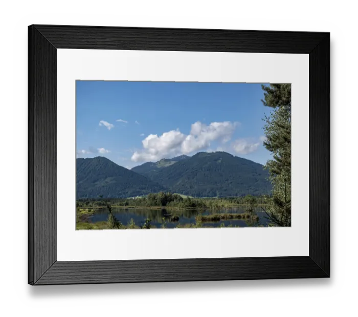 Framed Print : Picturesque moorland landscape with mountains under a blue sky and white clouds