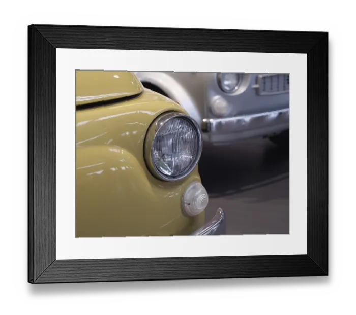 Framed Print : Close-up of a yellow vintage car with shiny chrome headlights