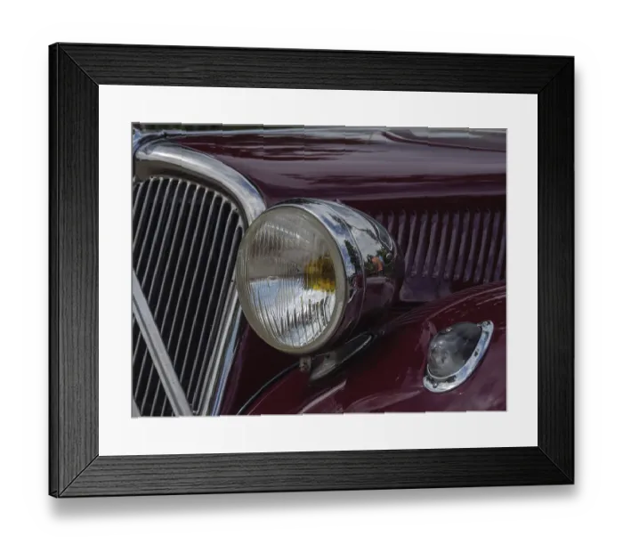 Framed Print : Close-up of a red vintage car with round chrome headlights