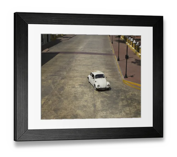 Framed Print : White beetle car driving on the main street of a mexican village Framed Print : White beetle car driving on the main street of a mexican village