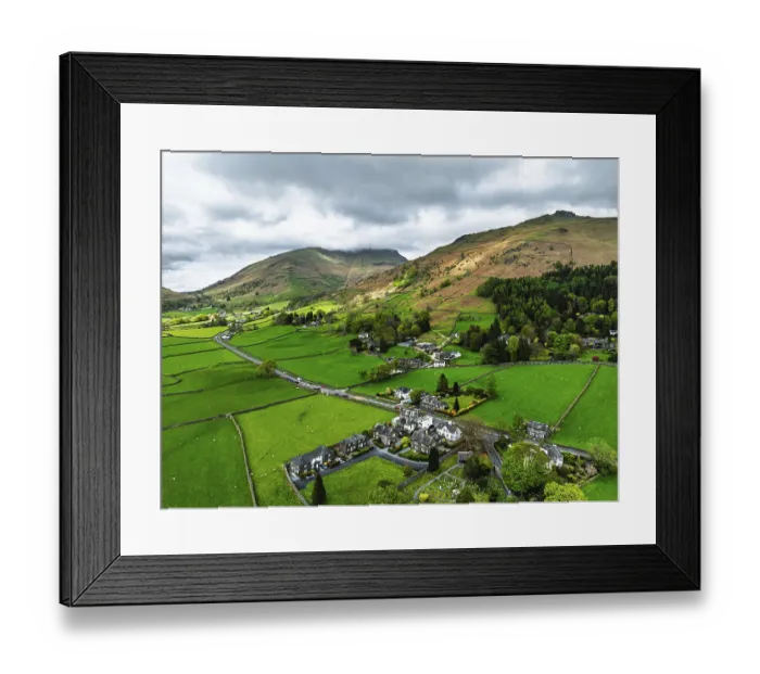 Framed Print : Farms and Mountains over road A591 from a drone