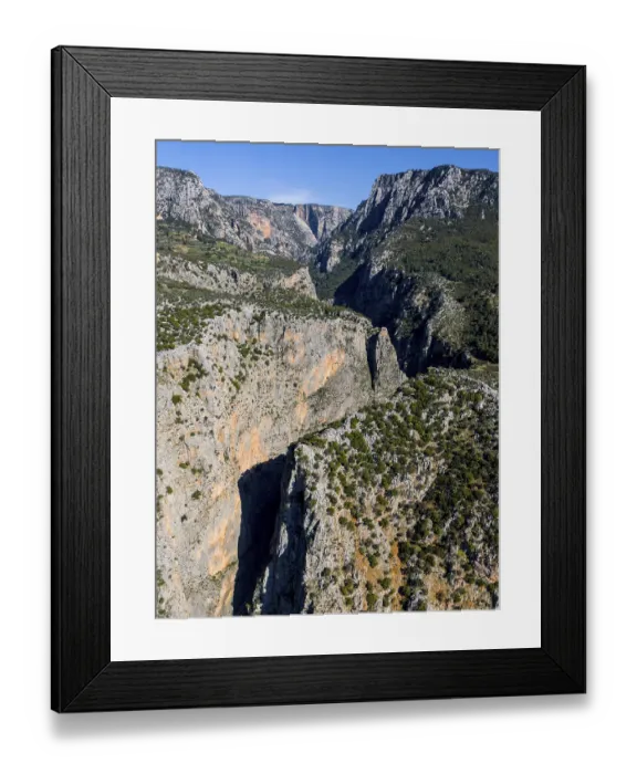 Framed Print : Majestic rock formations surrounded by green terrain and clear skies