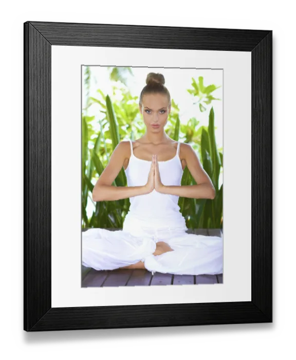 Framed Print : Beautiful glamorous woman practising yoga sitting in the lotus position with her hands together as though in prayer Framed Print : Beautiful glamorous woman practising yoga sitting in the lotus position with her hands together as though in prayer