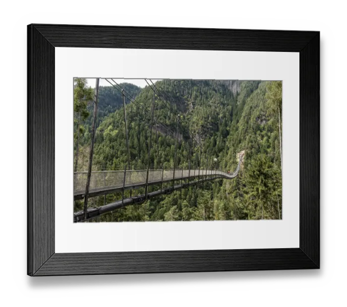 Framed Print : Long suspension bridge over a forest gorge in the South Tyrolean Alps