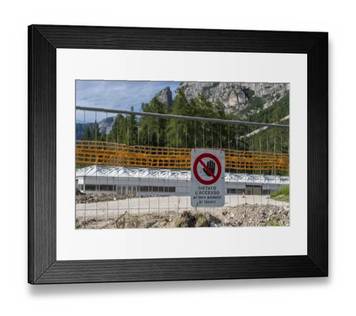 Framed Print : Prohibition sign on construction site barrier in front of mountain backdrop