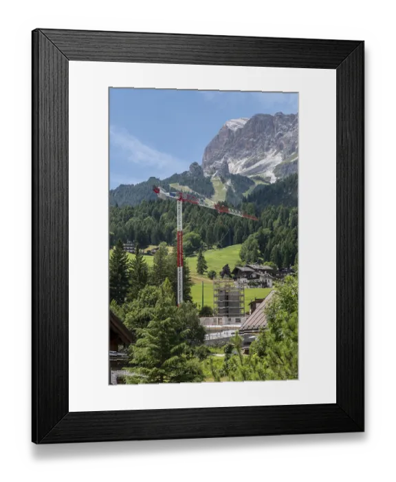 Framed Print : Construction crane in front of a mountain backdrop in Cortina
