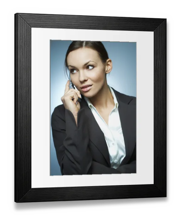 Framed Print : Beautiful and sexy brunette business woman isolated on clear background is using mobile phone