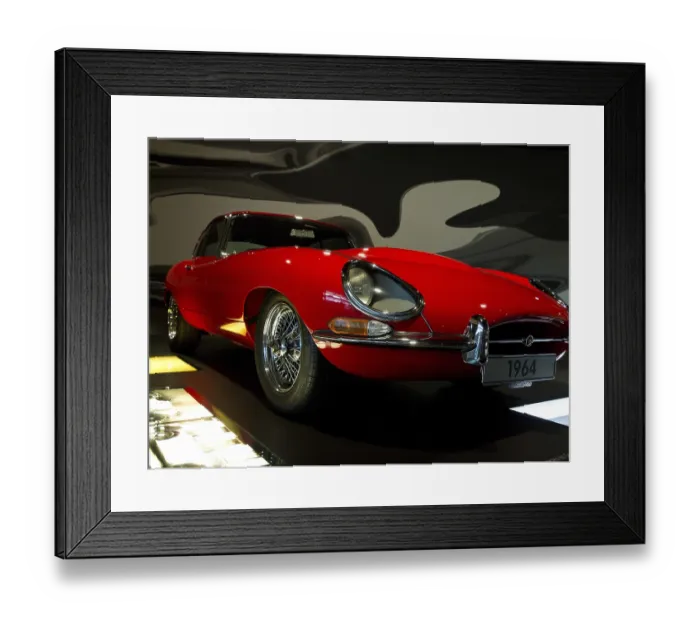 Framed Print : Red vintage car from the front view in an exhibition