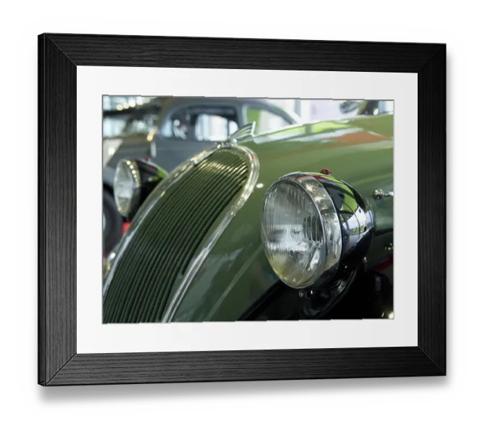 Framed Print : Green classic car with striking round headlights and chrome details