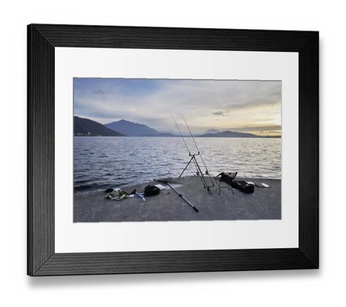 Framed Print : Two fishing rods on a tripod with many accessories set up on Lake Zug