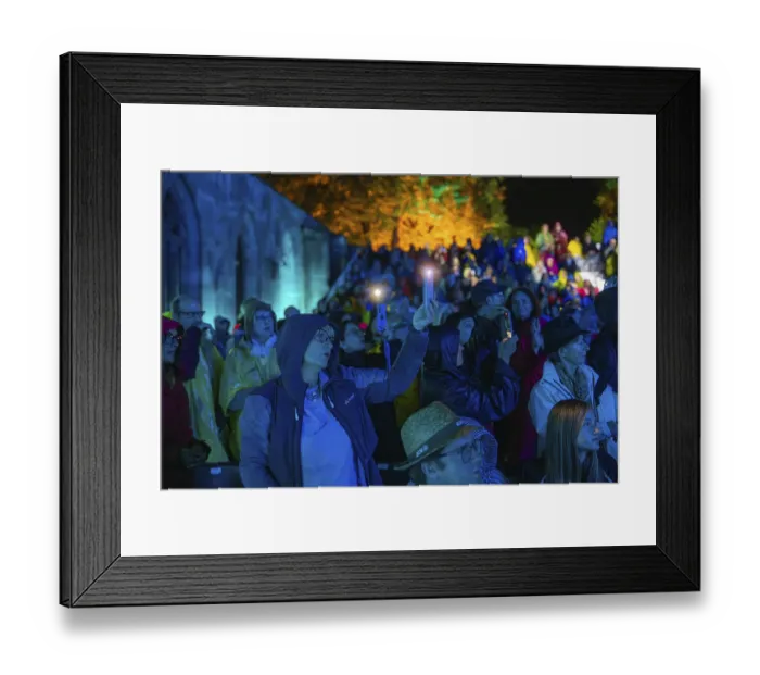Framed Print : Audience using mobile phones at a night-time event in rainwear Framed Print : Audience using mobile phones at a night-time event in rainwear