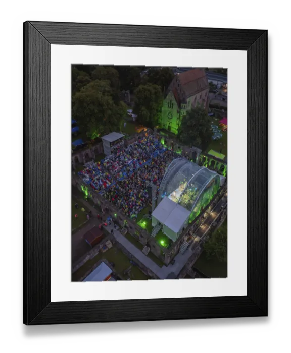 Framed Print : Illuminated concert at night with many visitors in a historic area surrounded by trees Framed Print : Illuminated concert at night with many visitors in a historic area surrounded by trees