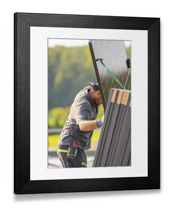 Framed Print : Worker positions solar panel with modern technology