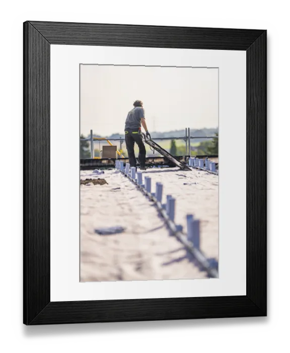 Framed Print : Worker prepares solar system on a sunny roof Framed Print : Worker prepares solar system on a sunny roof