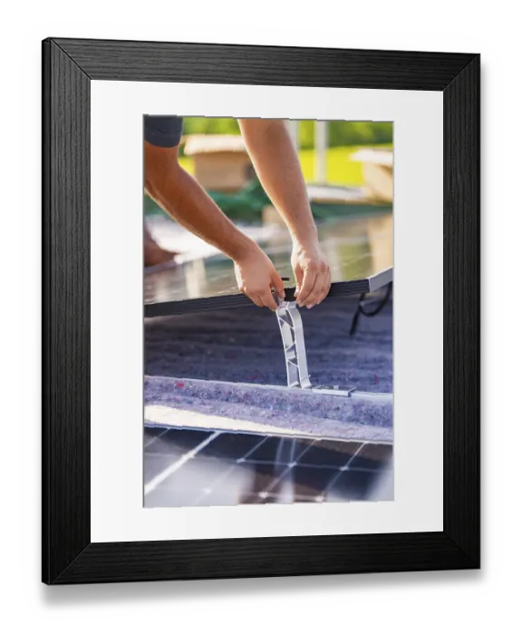 Framed Print : Close-up of hands installing a solar panel