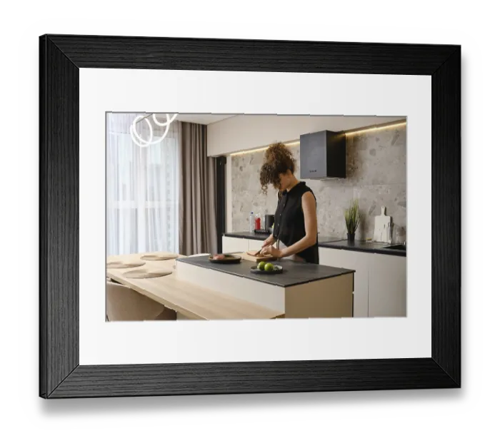 Framed Print : A woman cuts the skin crosswise on a duck breast standing in a kitchen