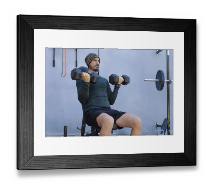 Framed Print : Focused male athlete sitting on a weight bench Framed Print : Focused male athlete sitting on a weight bench