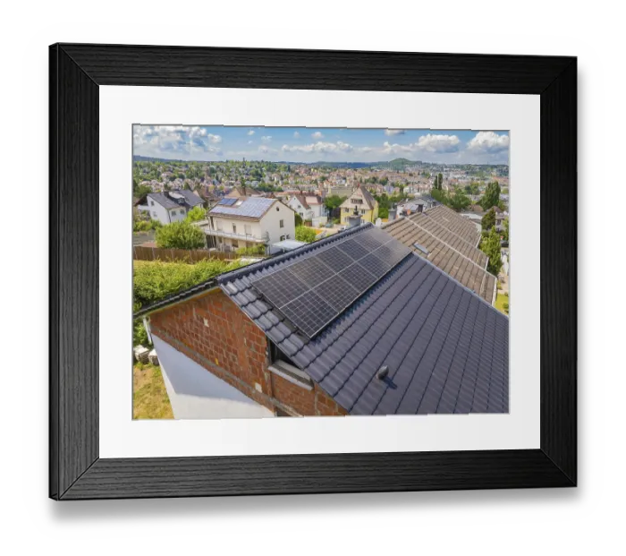 Framed Print : View of solar panels on a roof with a sweeping city view in the background