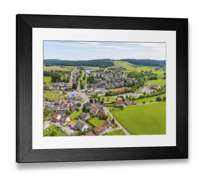 Framed Print : Village in a hilly, rural setting with scattered houses and green fields Framed Print : Village in a hilly, rural setting with scattered houses and green fields