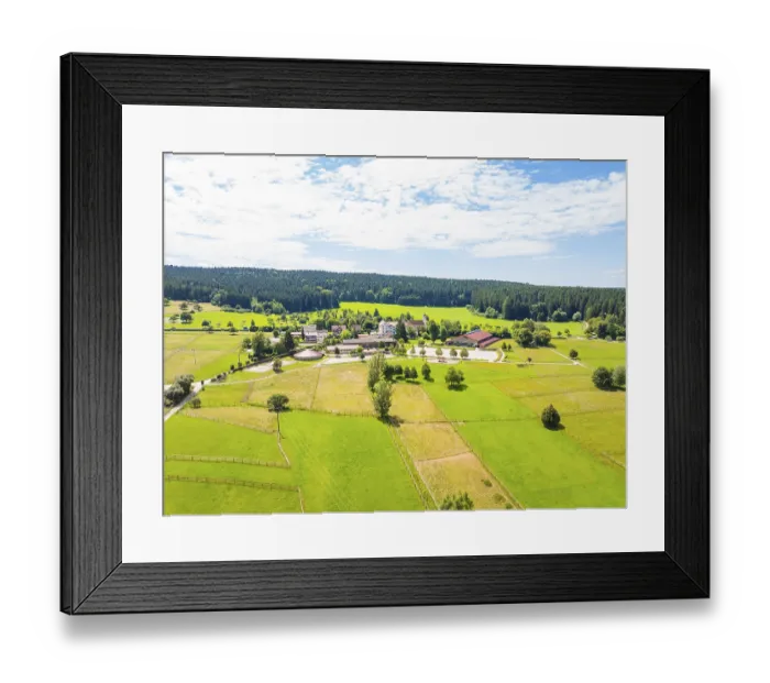 Framed Print : Village nestled in an expansive