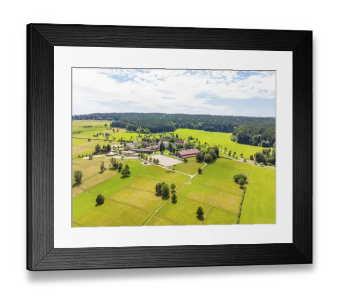 Framed Print : Village in the middle of green meadows and forests