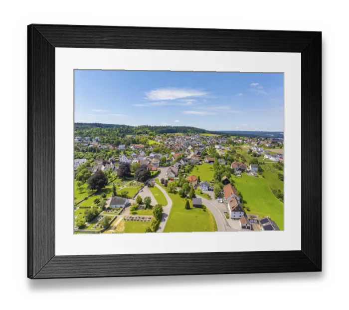Framed Print : Extensive village landscape under a clear sky with scattered houses and green fields Framed Print : Extensive village landscape under a clear sky with scattered houses and green fields