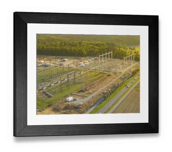 Framed Print : Substation under construction, surrounded by green fields and forests