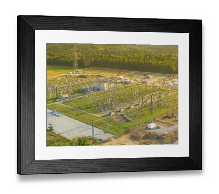 Framed Print : Substation with complex steel structures and technology surrounded by forests and green meadows