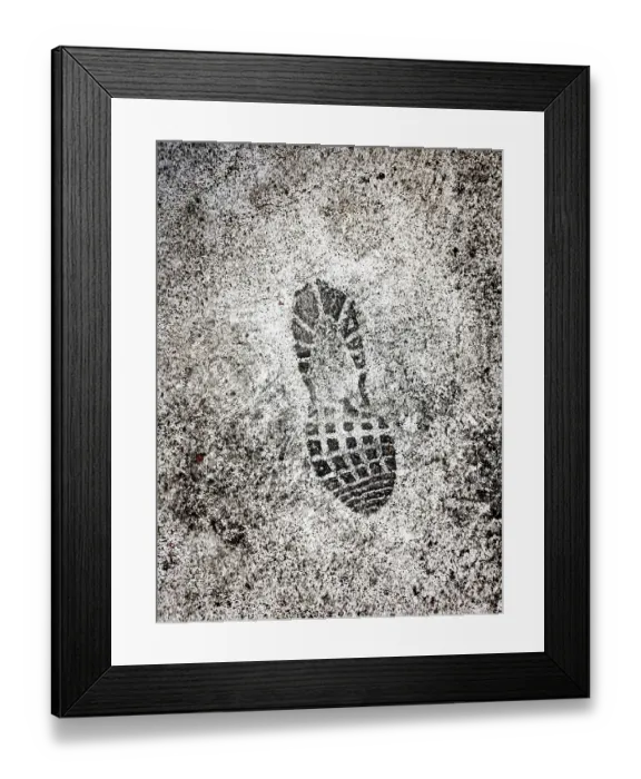 Framed Print : A distinct shoe print is marked on a wet surface